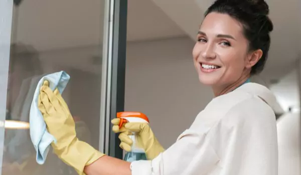 woman cleaning a window glass