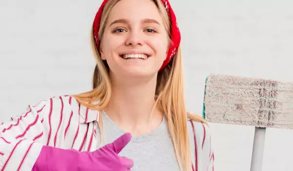 woman with a mop looking ready to clean her house