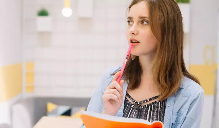 woman with a notepad thinking about something