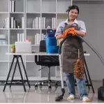 Cleaning in the room lady uses a mop and a vacuum cleaner to clean the floor
