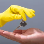 Man's hand receives the keys from cleaner's hand