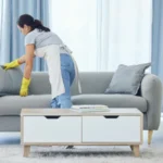 It looks good now shot of a young woman cleaning at home