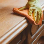 Cleaning and maintenance of wooden furniture chair table with rag and cleaning agent